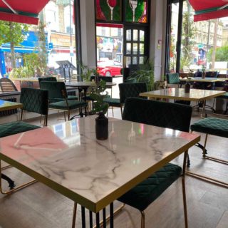 White levanto marble effect tabletops at Fed & Watered Acton by DeFrae Contract Furniture