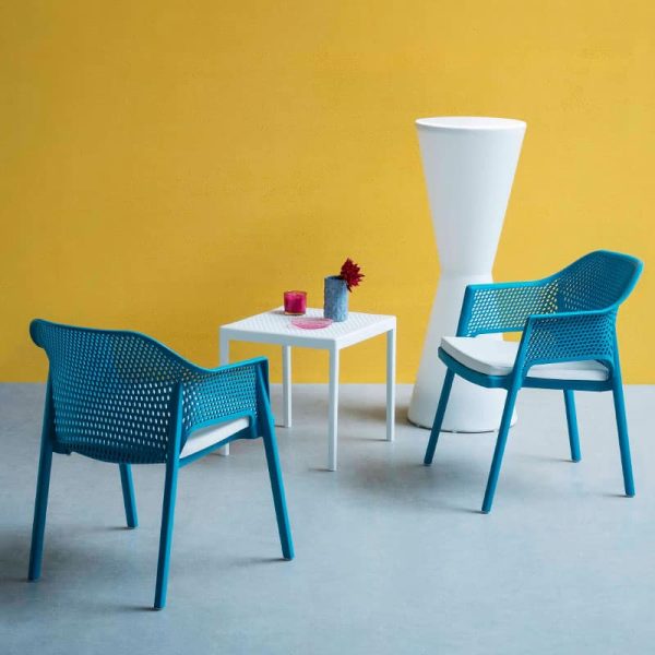 Minush Armchair Outside DeFrae Contract Furniture with cushion Sky Blue in situ