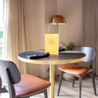 Egger laminate and marble tabletops with Zeus brass bases at Embers Bar & Grill