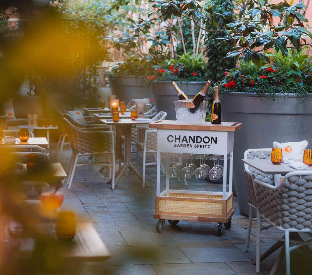 Luxury outdoor hotel terrace with woven rope chairs and dining tables supplied by DeFrae Contract Furniture.