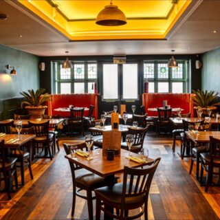 Steakhouse restaurant furniture supplied by DeFrae Contract Furniture, featuring banquette seating, solid wood tables, and contract dining chairs for a commercial hospitality interior.