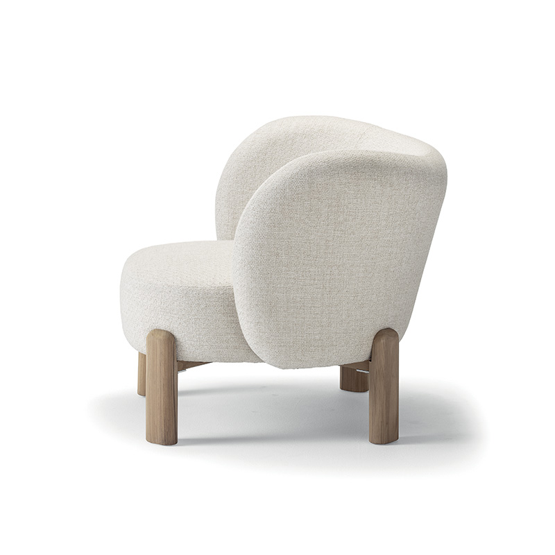 Natura teak outdoor lounge chair with padded Olefin cushion for outdoor hospitality venues including hotels and bars