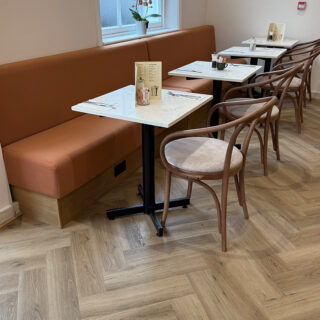 Interior of Peach Hertford showing classic bentwood restaurant chairs and banquette seating