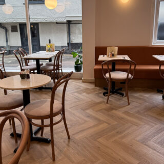 Interior of Peach Hertford showing classic bentwood restaurant chairs and banquette seating