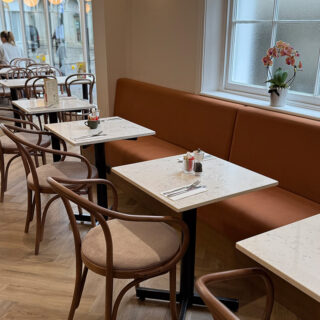 Interior of Peach Hertford showing classic bentwood restaurant chairs and banquette seating
