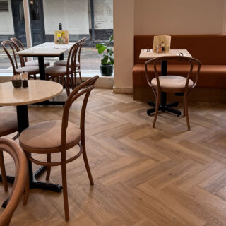 Interior of Peach Hertford showing classic bentwood restaurant chairs and banquette seating