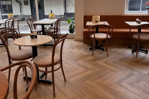Interior of Peach Hertford showing classic bentwood restaurant chairs and banquette seating