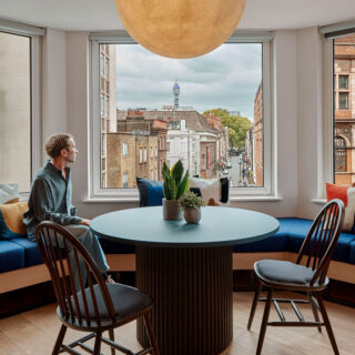Curved upholstered bench seating and meeting table overlooking Soho installed by DeFrae Contract Furniture at Talon OOH London offices.